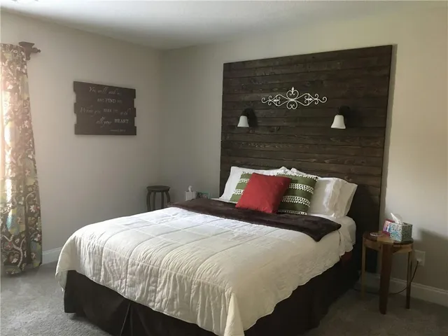 a bed sitting in a bedroom next to a window