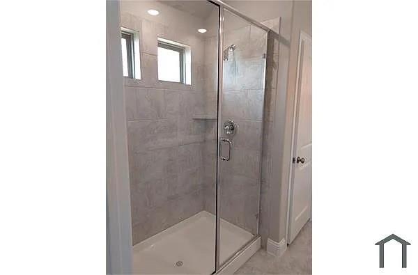 4254 Calla Drive Forney, TX 75126 - Photo 2 of 7 a bathroom with a glass shower door