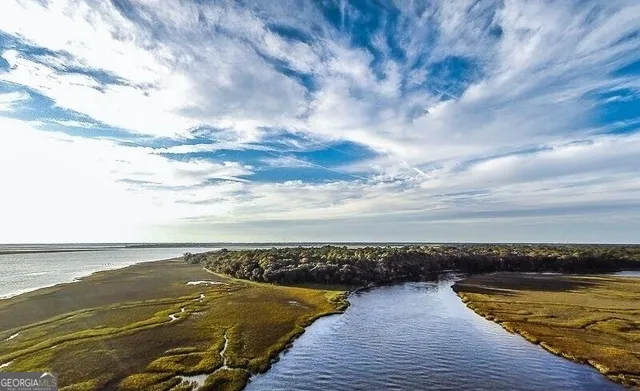 a view of a house with pool and chairs