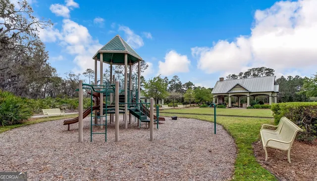 a view of a backyard with plants and lake view