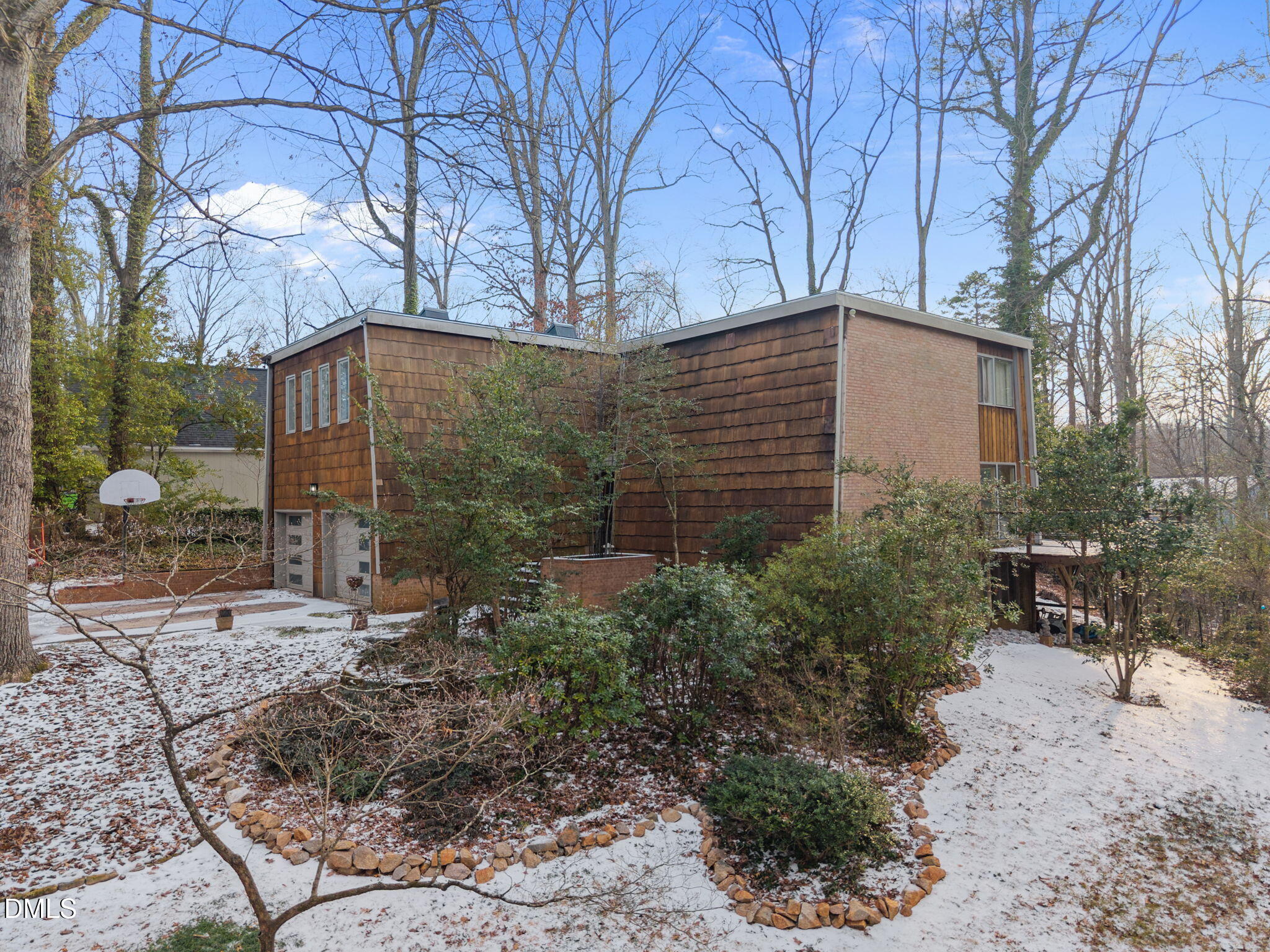 1108 Hemingway Drive Raleigh, NC 27609 - Photo 62 of 68 a backyard of a house with large trees and outdoor seating