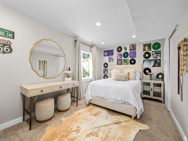 7 Sterling Loop Vineyard, UT 84059 - Photo 33 of 43 Carpeted room featuring a window with natural light, recessed lighting, and a built-in closet with a sliding door