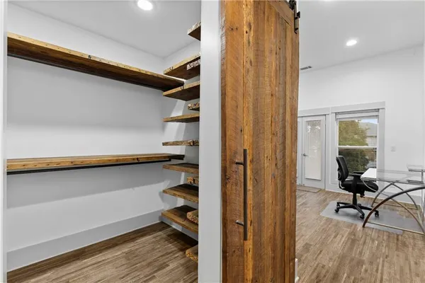 a bedroom with a bed and wooden floor