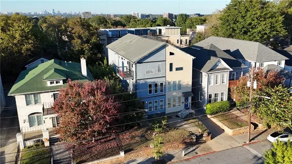 an aerial view of multiple houses with yard