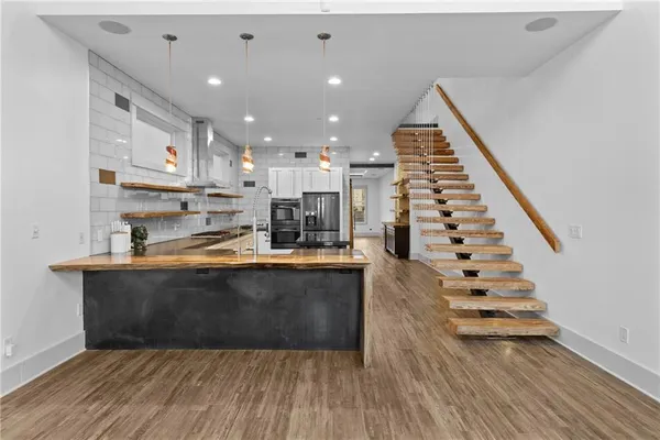 a view of kitchen with sink and wooden floor