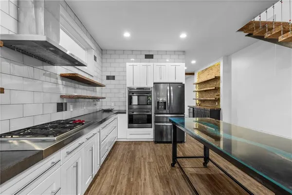 a kitchen with granite countertop a stove and a refrigerator