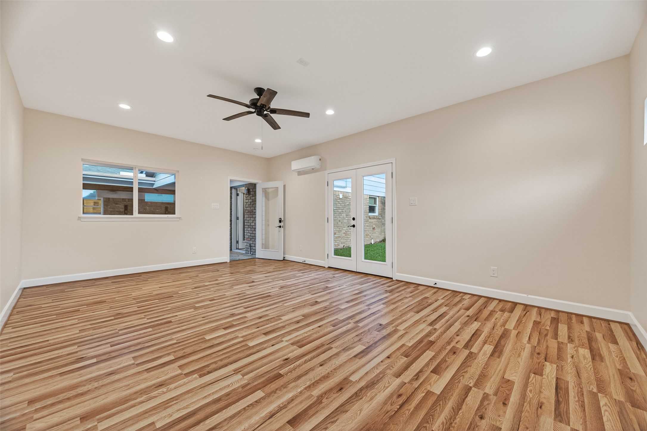 5638 Sanford Road Houston, TX 77096 - Photo 7 of 41 Oversized window overlooks a beautiful cedar plank-covered backyard patio, bringing in natural light and serene outdoor views.