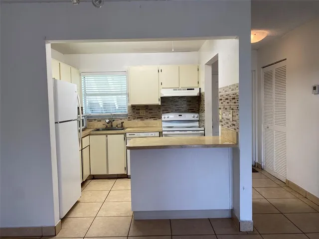 a kitchen with stainless steel appliances a sink stove and cabinets