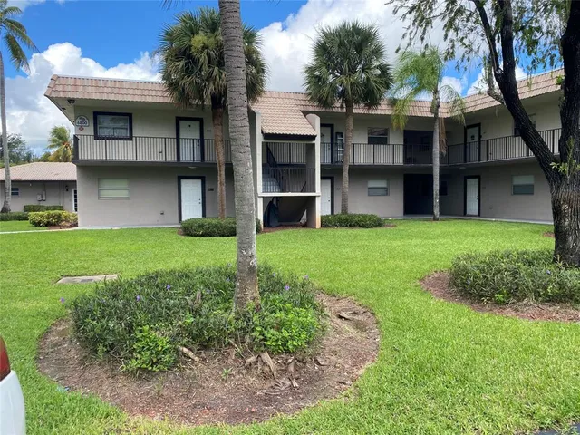a view of a house with yard and a garden