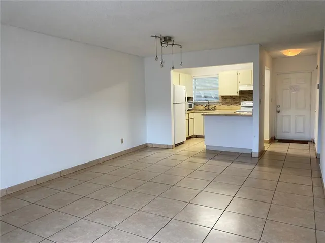 a view of a kitchen with a sink and a living room