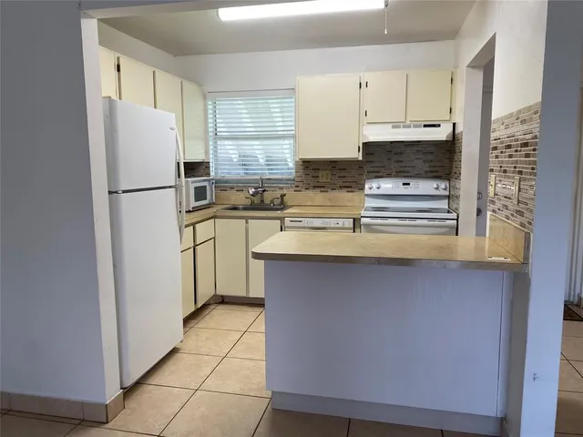 a kitchen with stainless steel appliances a refrigerator sink and cabinets