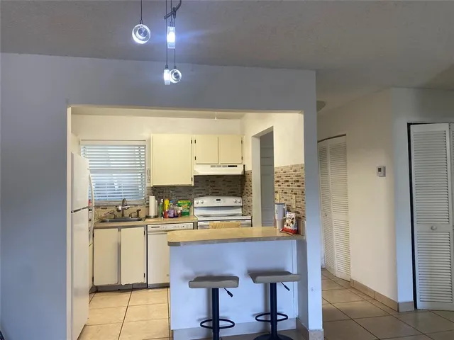 a kitchen with a sink cabinets and window