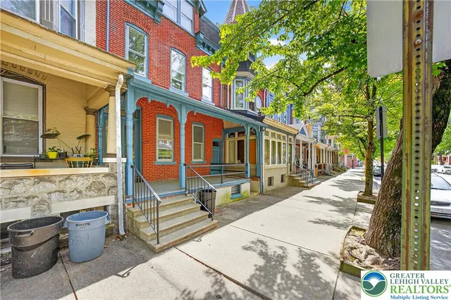 a view of a patio with couches table and chairs and potted plants