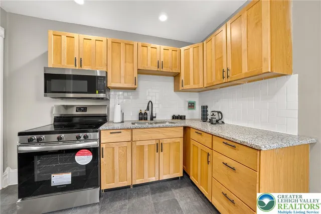 a kitchen with a sink a window and cabinets