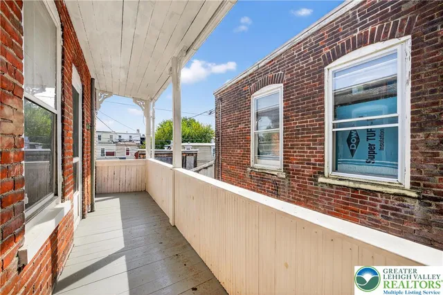 a view of balcony with a large window and wooden floor
