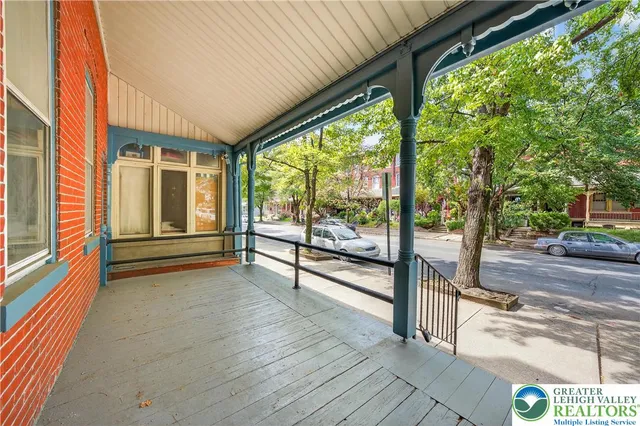 a view of a porch with wooden floor and stairs