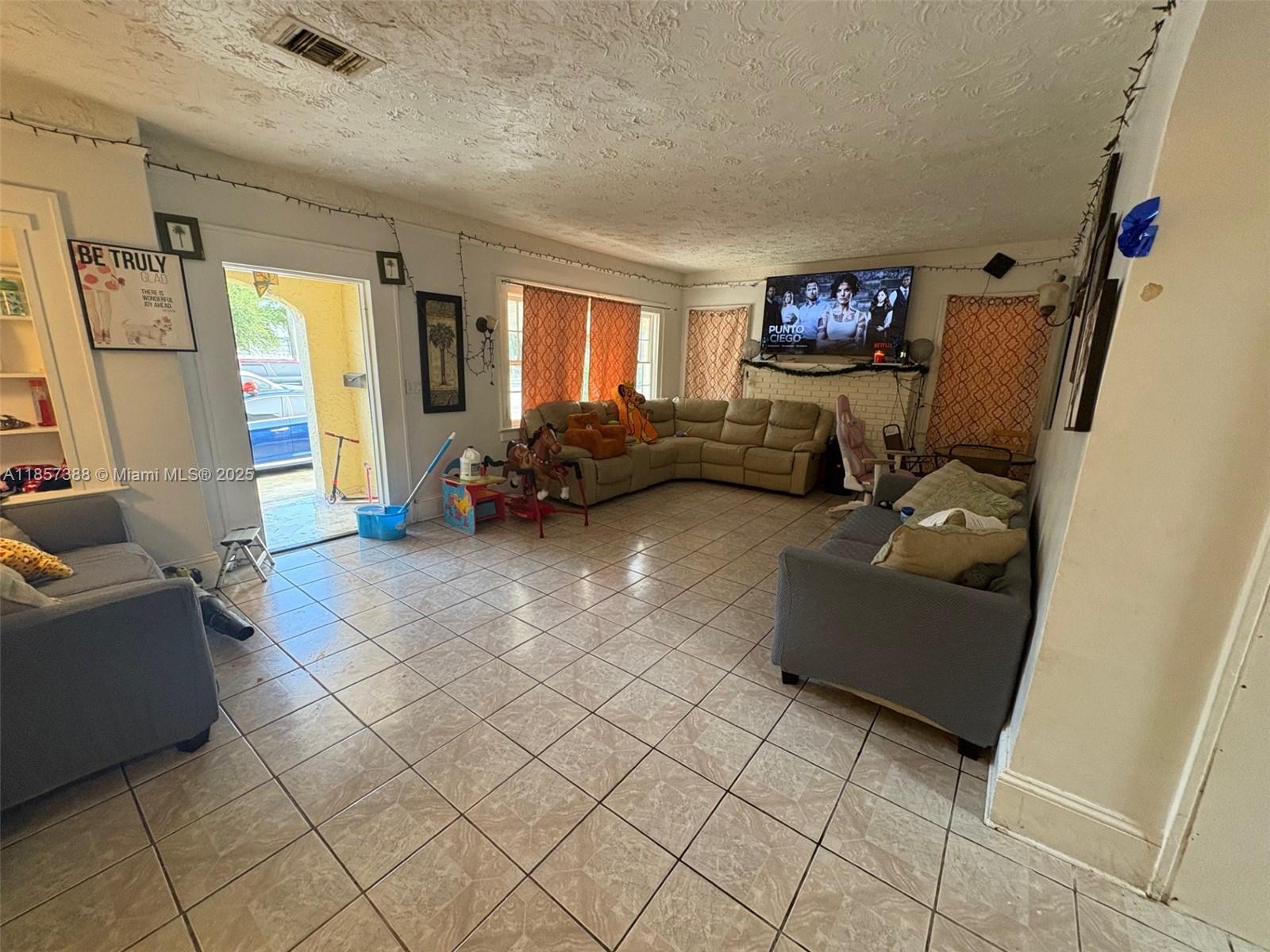 2619 Southwest 5th Street Miami, FL 33135 - Photo 16 of 17 a living room with furniture and a flat screen tv