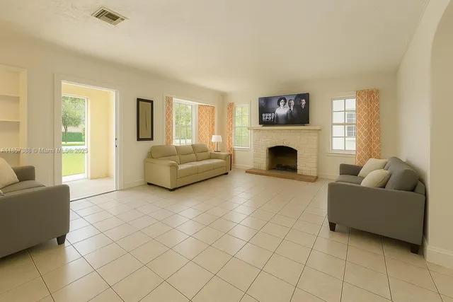 a living room with furniture and a fireplace