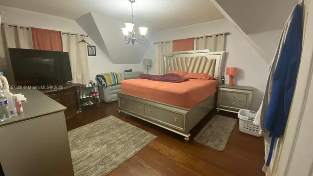 a bedroom with a bed and flat screen tv