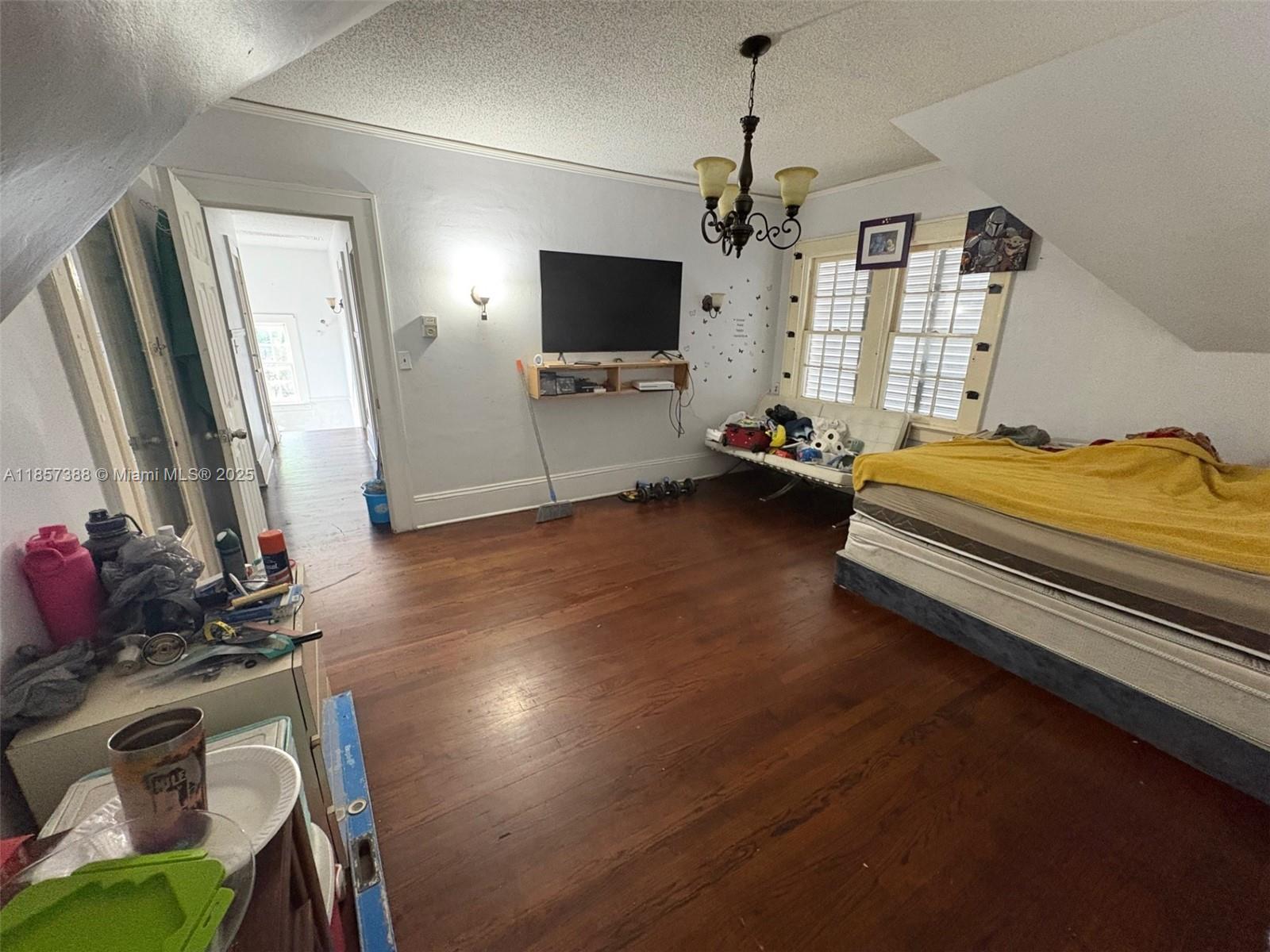 2619 Southwest 5th Street Miami, FL 33135 - Photo 10 of 17 a bedroom with bed tv and window