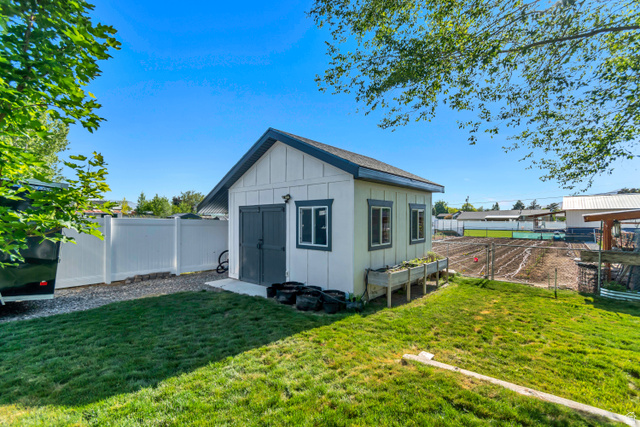 332 South 500 West Payson, UT 84651 - Photo 41 of 50 Detached storage shed with board and batten siding, multiple windows, and a concrete foundation