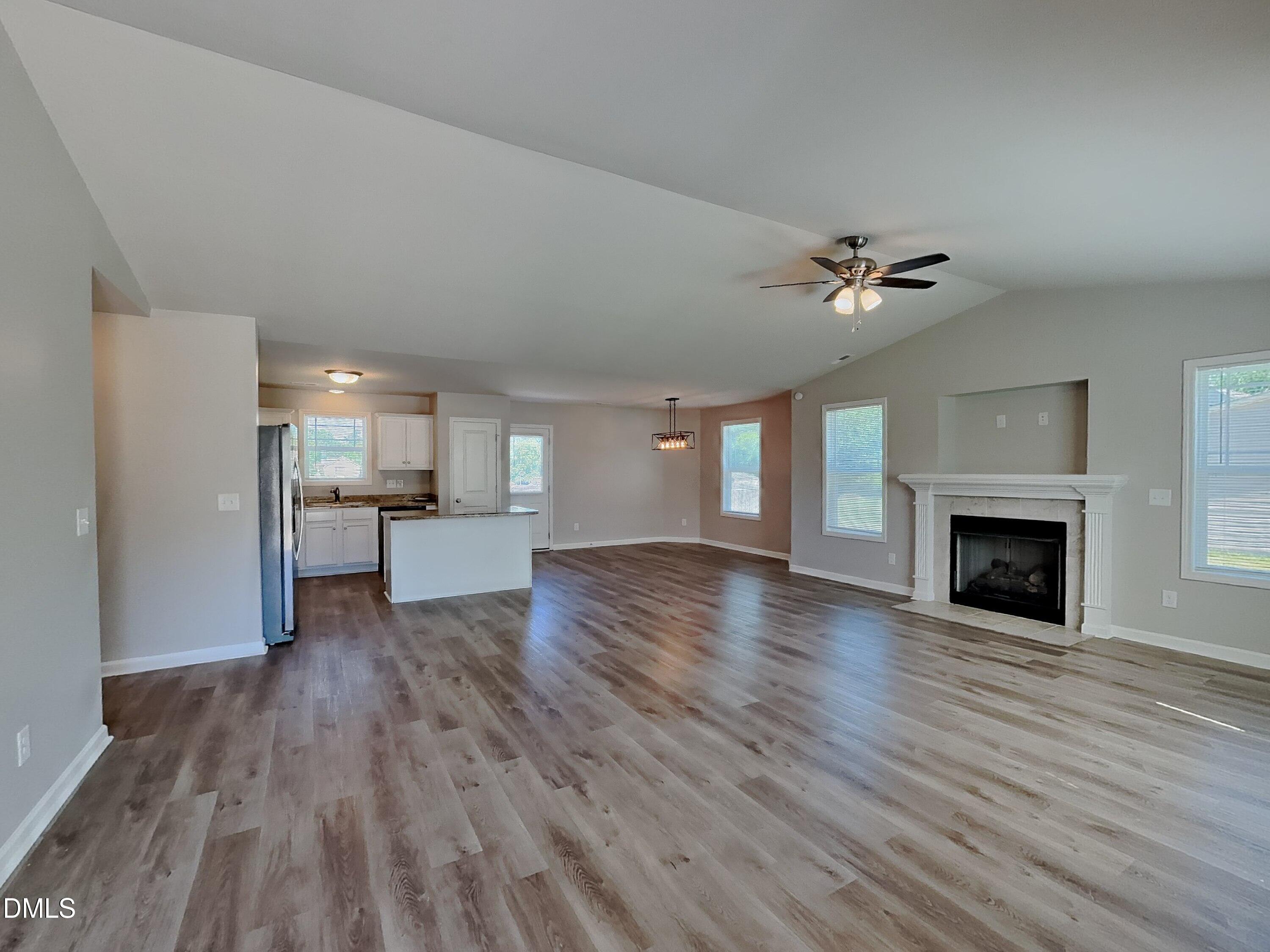 123 Willow Ridge Circle Willow Spring, NC 27592 - Photo 2 of 15 a view of empty room with wooden floor and fireplace