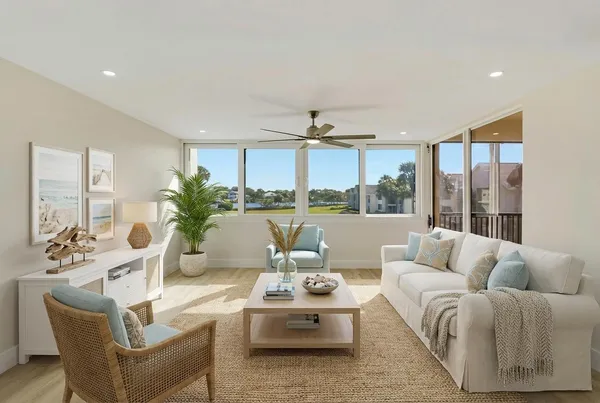 a living room with furniture and a dining table with kitchen view