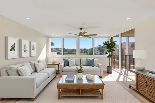 a living room with furniture and a floor to ceiling window
