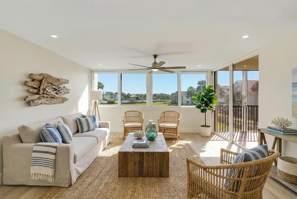 a view of a dining room with furniture a chandelier and wooden floor