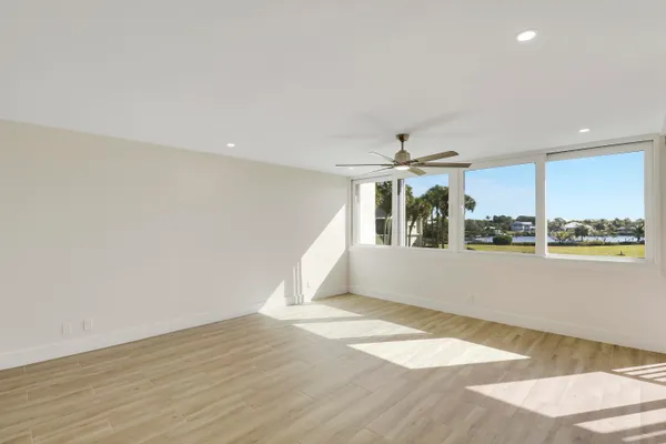 a view of a dining room with furniture a chandelier and wooden floor