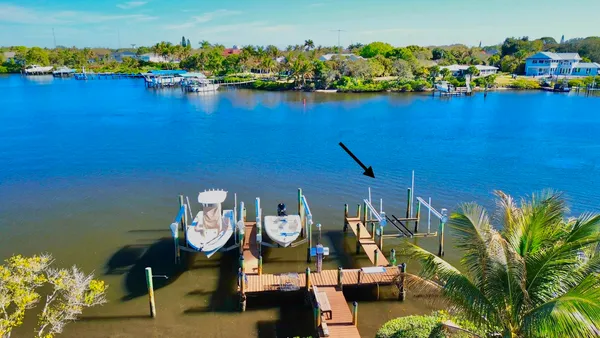 a view of a big room with wooden floor and a kitchen