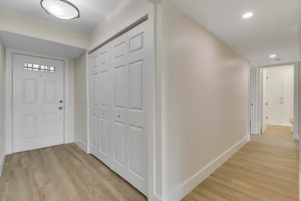 a view of a kitchen with a dishwasher cabinets and wooden floor
