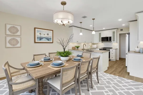 a bathroom with a granite countertop sink mirror vanity bathtub and a toilet