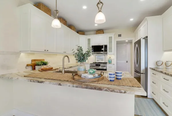 an aerial view of lake and residential houses with outdoor space
