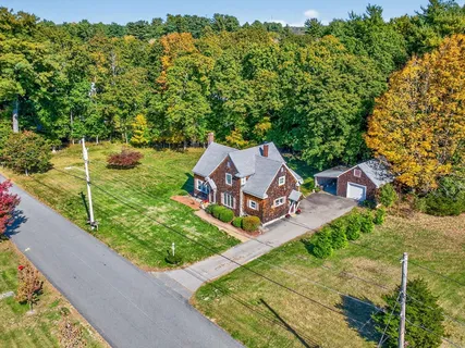 an aerial view of a house with garden space and street view