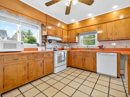 a kitchen with sink cabinets and window