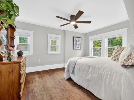 a bedroom with a bed and a large window