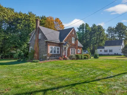 a view of a house with a yard and garage