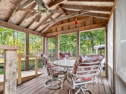 a dining room with furniture water view and wooden floor