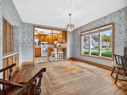 a view of a livingroom with furniture window and wooden floor