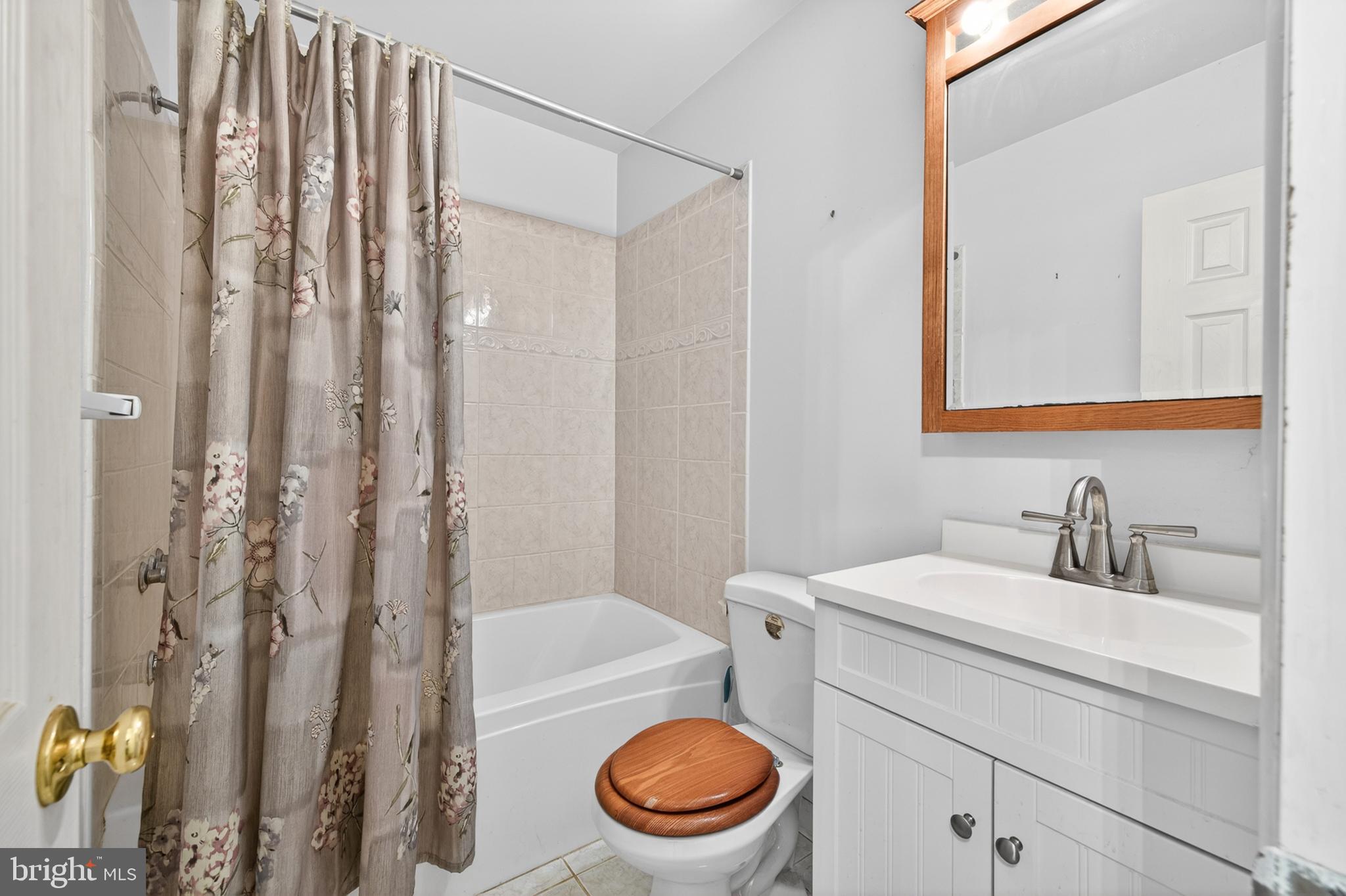 3701 Ebright Road Chadds Ford, PA 19317 - Photo 25 of 45 a bathroom with a sink a toilet and shower curtain