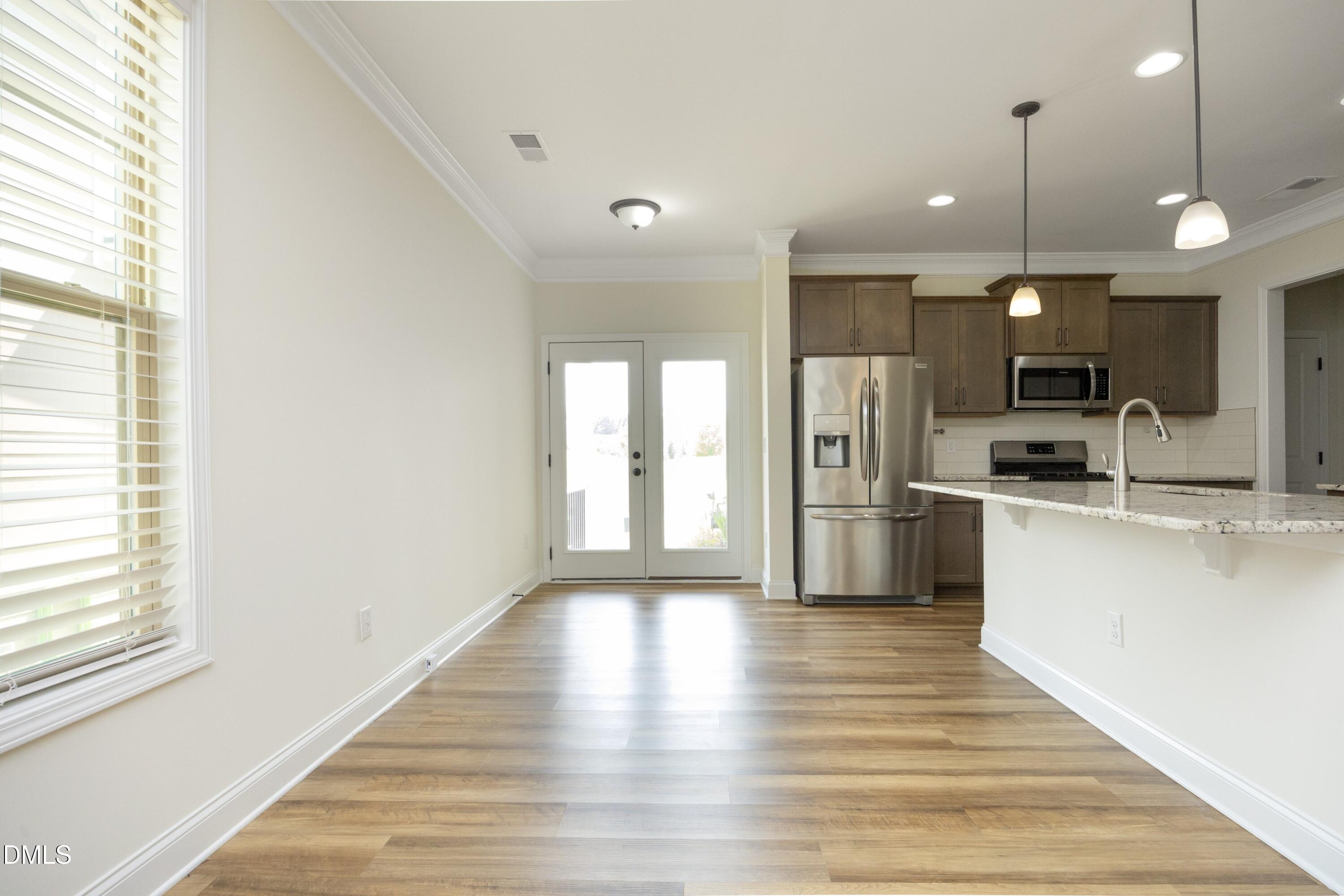 824 Country Downs Road Wake Forest, NC 27587 - Photo 14 of 41 a kitchen with stainless steel appliances granite countertop a refrigerator a sink dishwasher a stove and white countertops with wooden floor