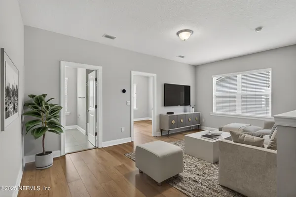 a view of a hallway with wooden floor