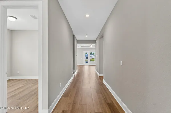 a view of an empty room with wooden floor