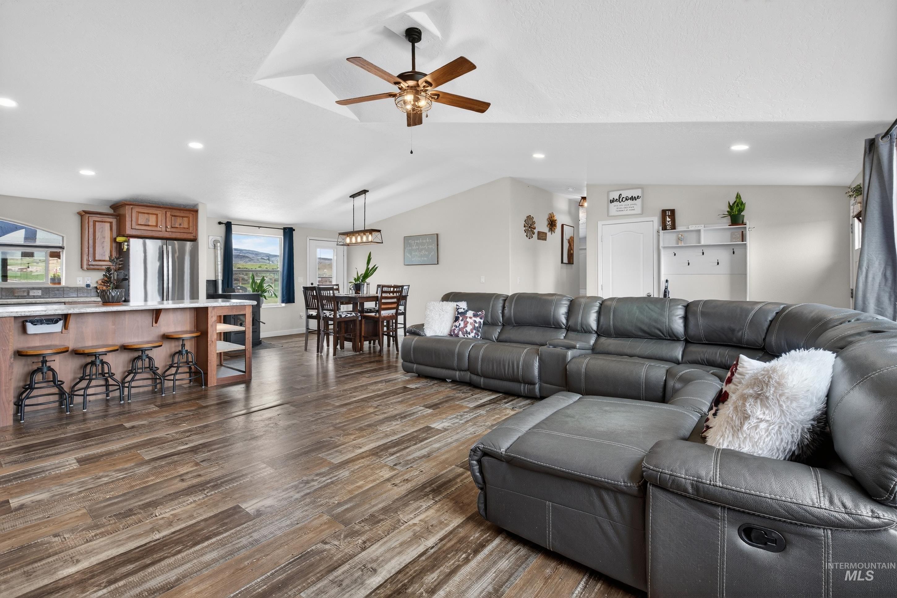 728 Chase Lane Melba, ID 83641 - Photo 14 of 48 Living area featuring recessed lighting, dark wood finished floors, a ceiling fan, and vaulted ceiling