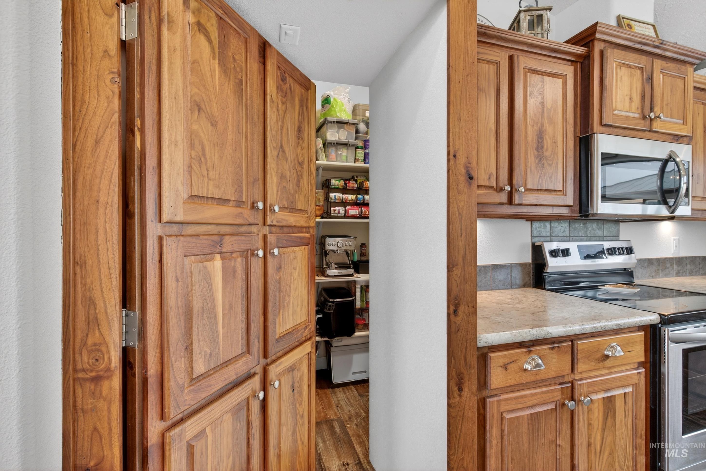 728 Chase Lane Melba, ID 83641 - Photo 20 of 48 Kitchen with stainless steel appliances, wood finish cabinets, light countertops, and wood finished floors