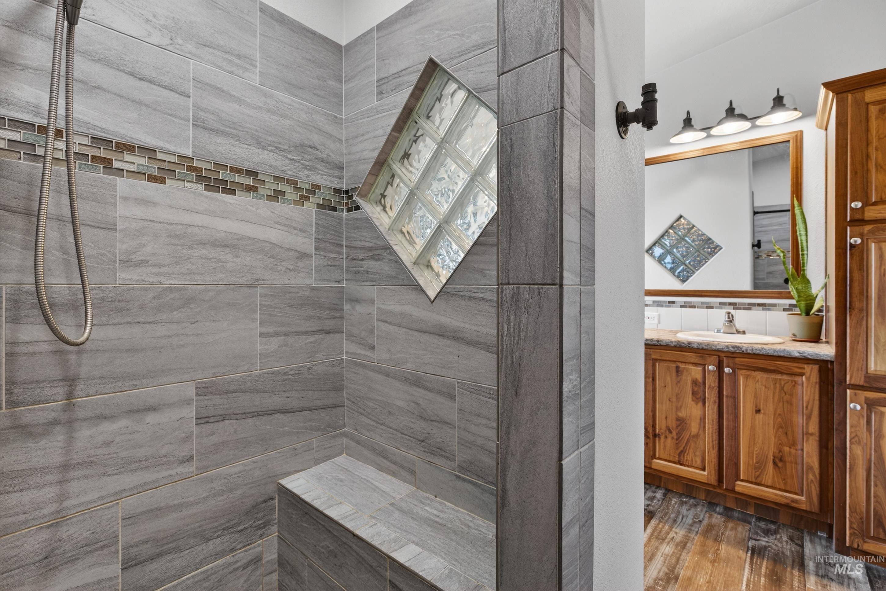 728 Chase Lane Melba, ID 83641 - Photo 27 of 48 Bathroom with vanity, a walk in shower, and dark wood-style flooring