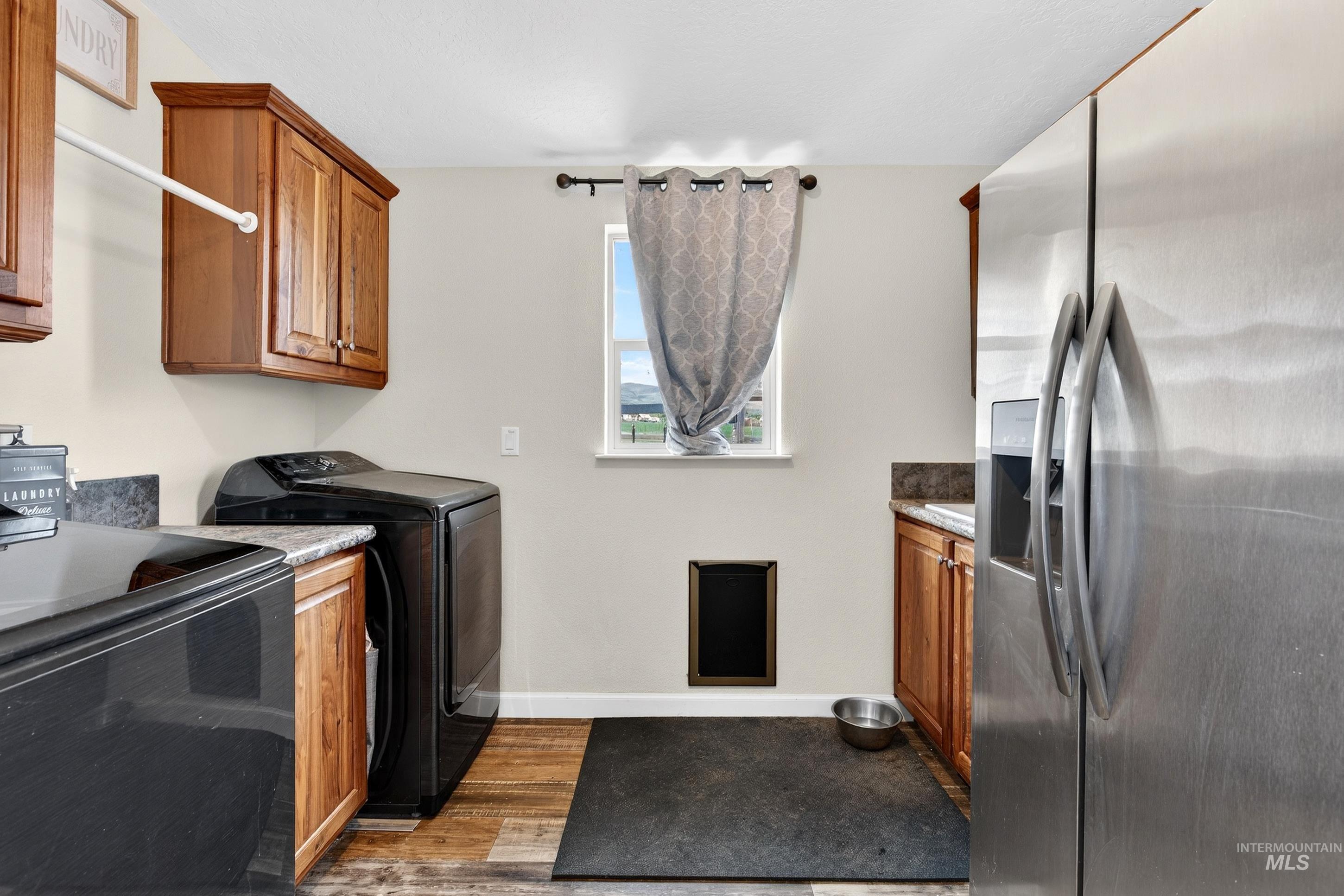 728 Chase Lane Melba, ID 83641 - Photo 34 of 48 Laundry area with light wood-style flooring and baseboards
