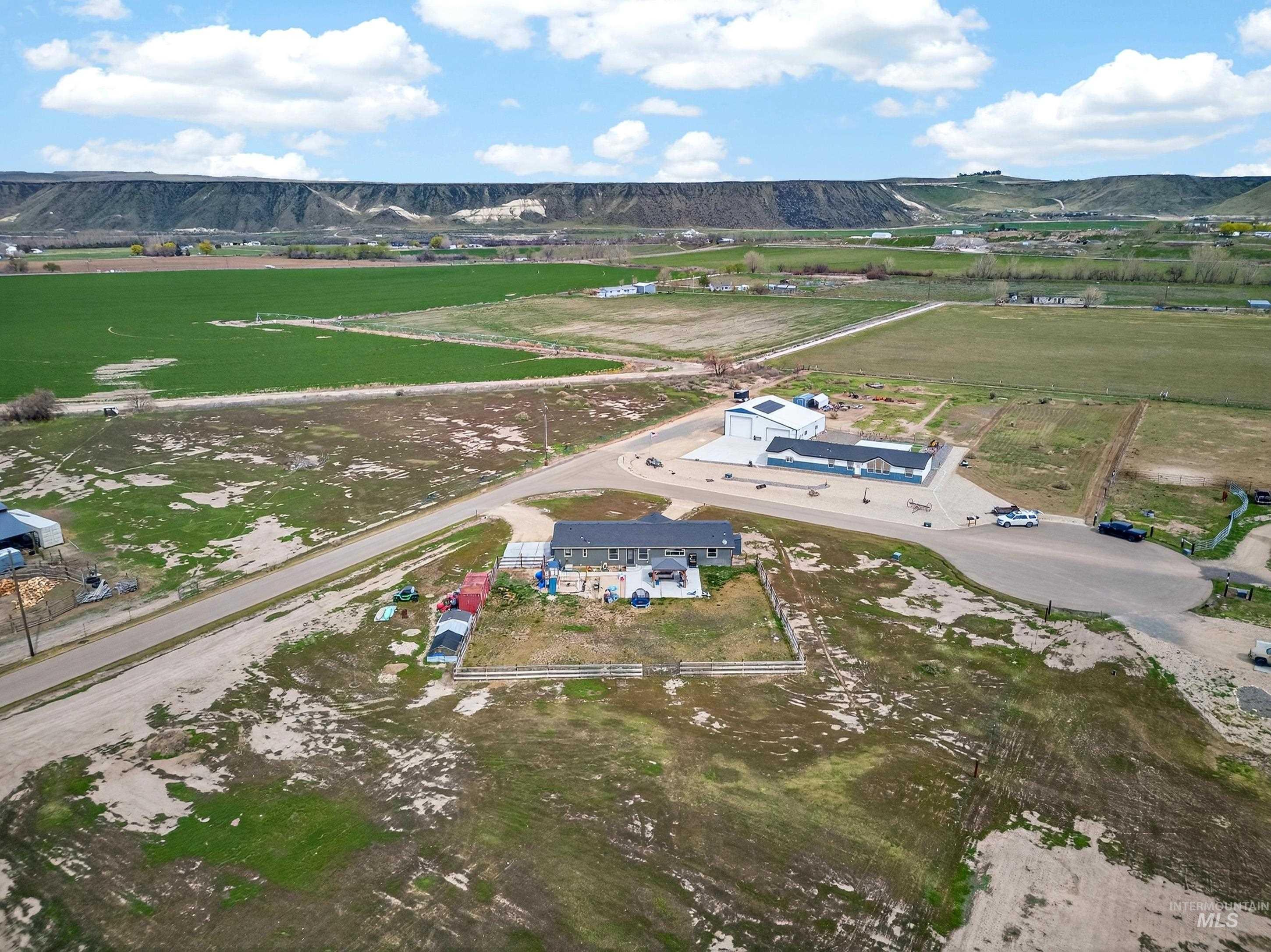 728 Chase Lane Melba, ID 83641 - Photo 45 of 48 Aerial view of property's location with rural landscape and a mountain backdrop