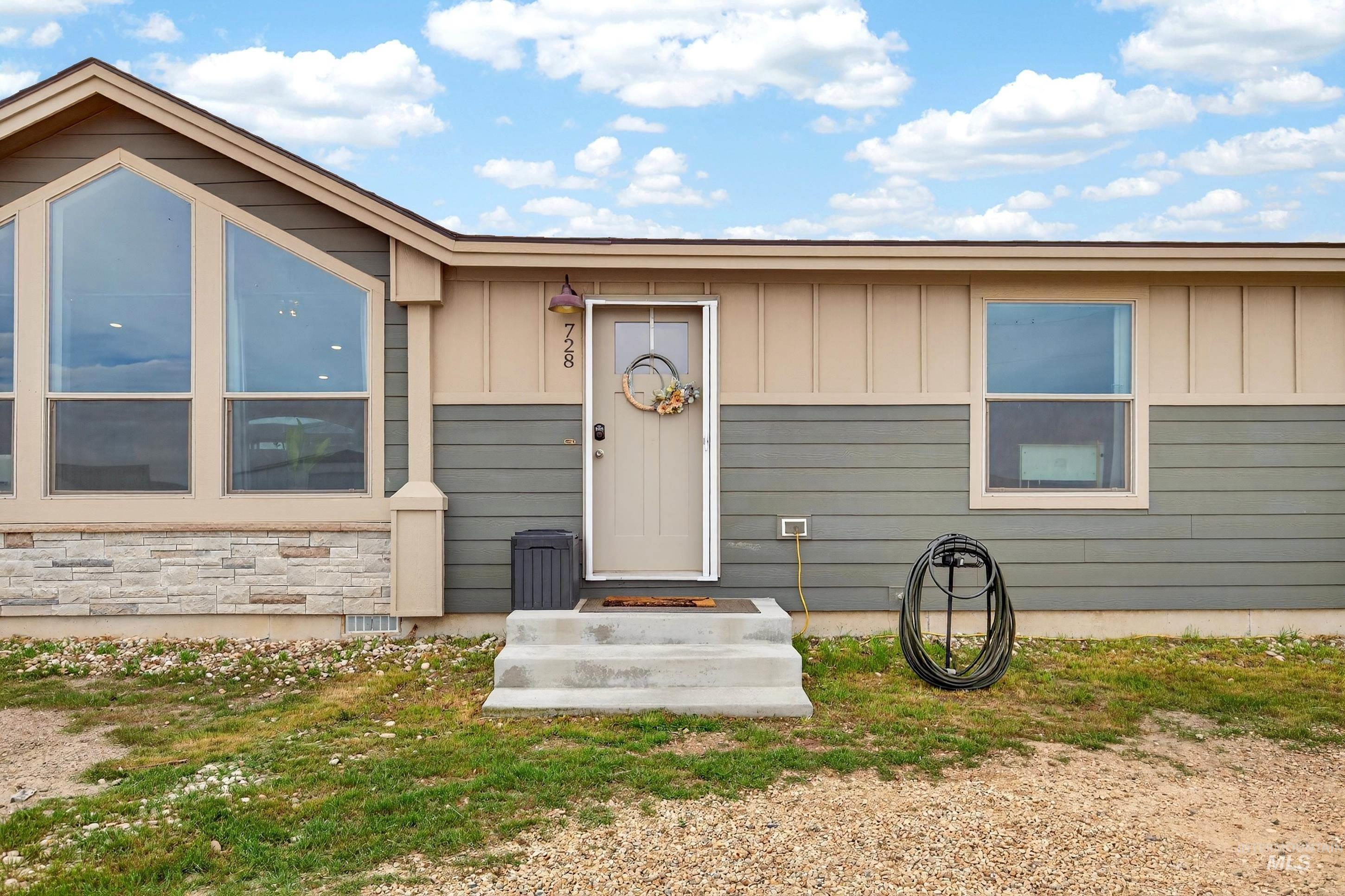 728 Chase Lane Melba, ID 83641 - Photo 7 of 48 Property entrance featuring board and batten siding and stone siding